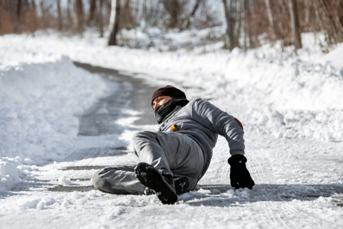 Injured man lying on the road, downfall and accident on winter season, black ice